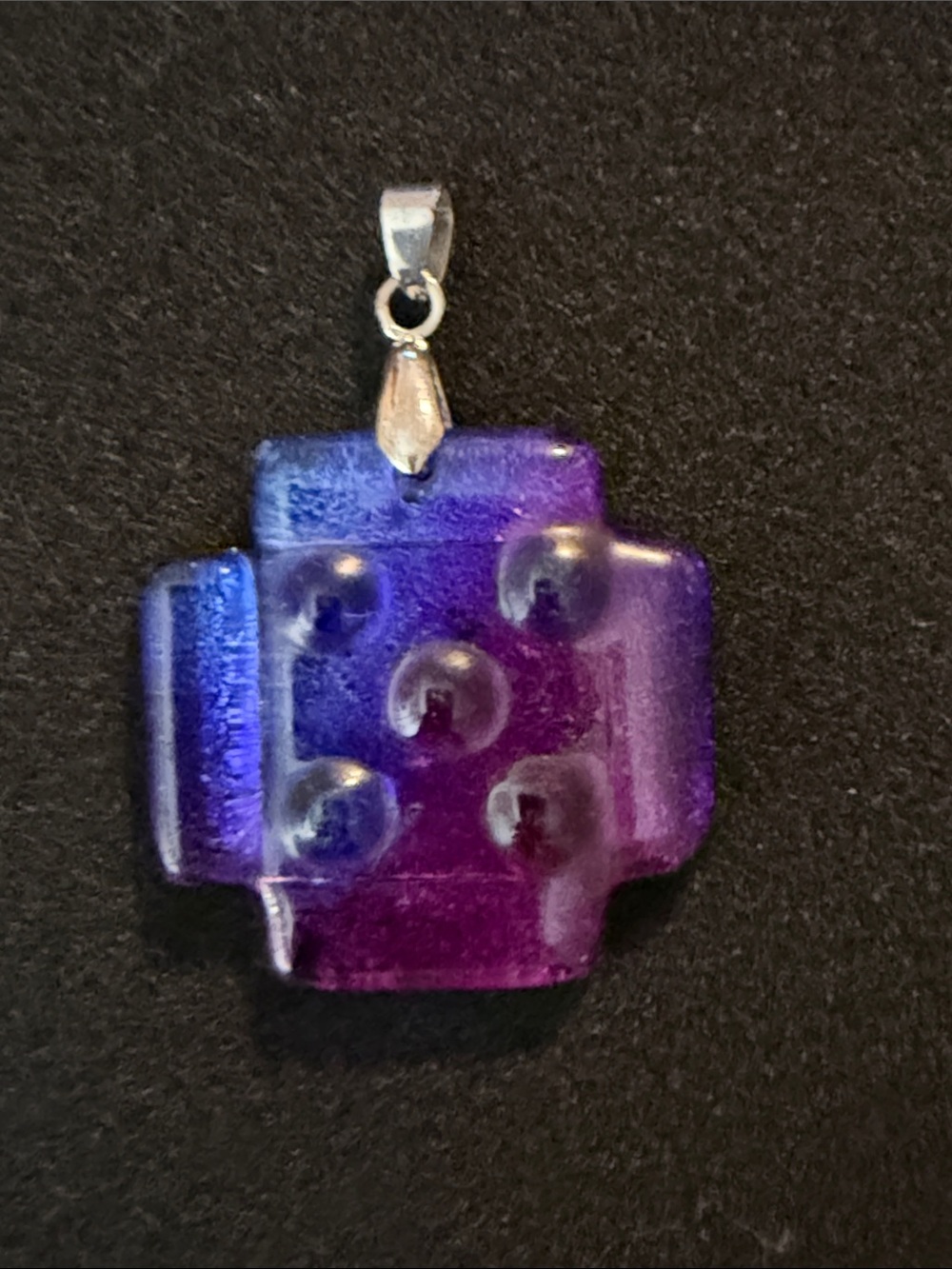 Dichroic glass pendant featuring a blue and purple geometric design